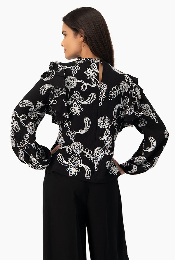 Blusa de manga larga y volantes