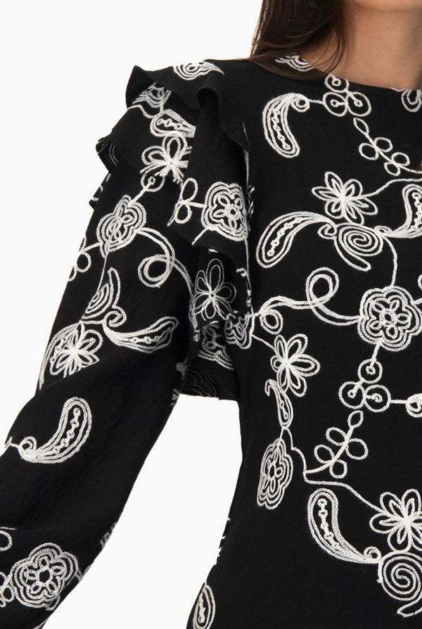 Blusa de manga larga y volantes