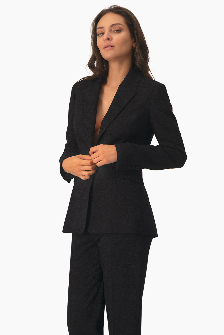 Blazer negro con bolsillos y accesorio de flor, estilo elegante