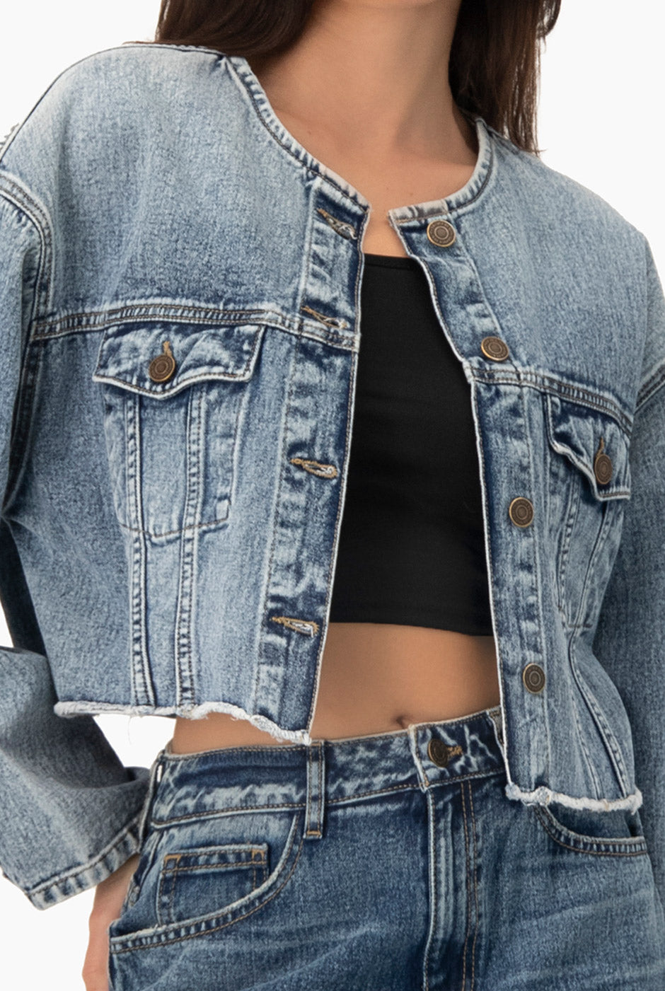 Chamarra denim corta azul claro con botones y bolsillos frontales